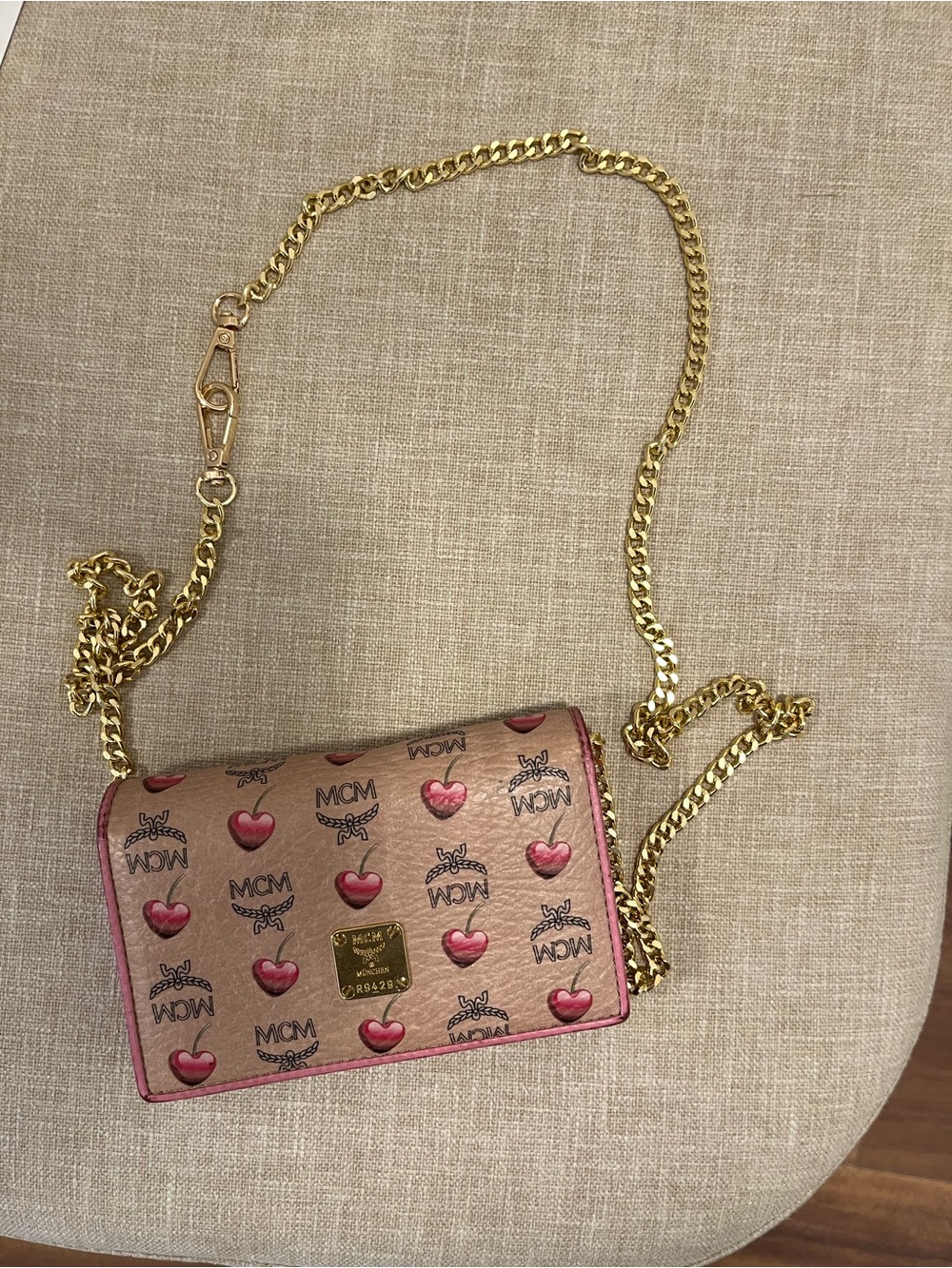MCM Metallic Pink Logo Heart Crossbody can be used with a gold chain